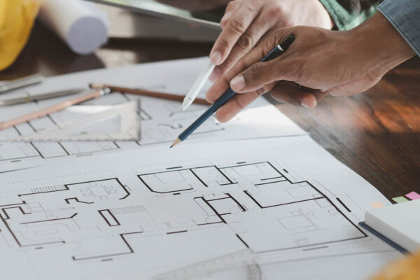 The home design architects are reviewing the house plan draft, the project commissioned by the client, and the custom design before delivery. Interior design and decoration ideas.